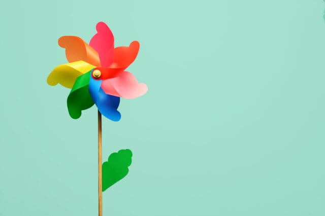 Colorful flower shaped pinwheel with leaf